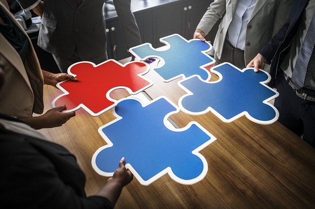 People around a table with a large jigsaw